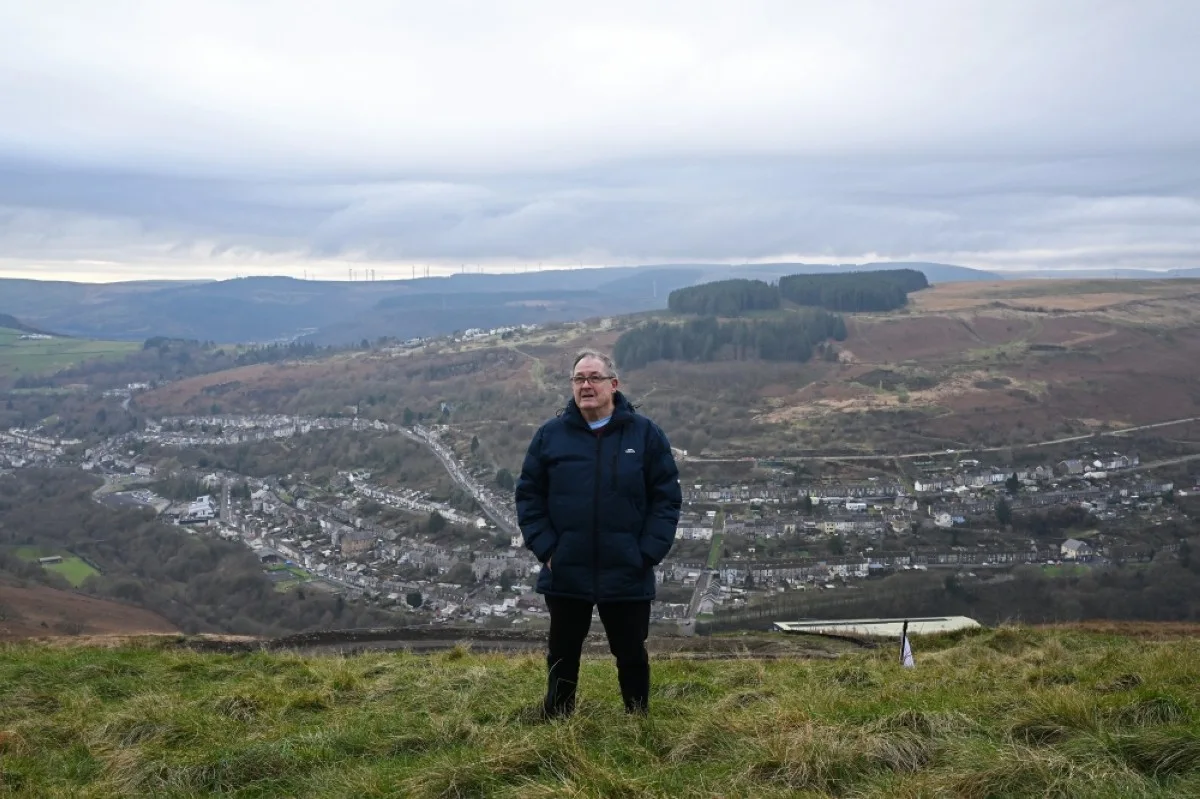 RHONDDA, UK: Former miner and local resident Roy Jones poses for a photograph on the hill top above Tylorstown on December 6, 2023 in the Rhondda Valley, south Wales. -- AFP