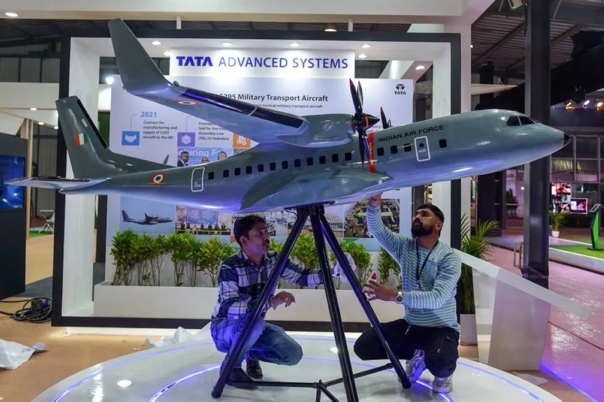 GANDHINAGAR: People work on a model of Indian Air Force (IAF) military transport aircraft at a stall of Tata Advanced Systems on the eve of inauguration of Vibrant Gujarat Global Summit 2024 in Gandhinagar on January 8, 2024. – AFP