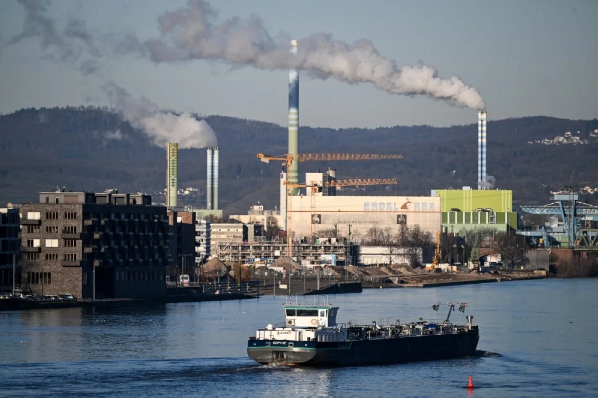 MAINZ: A commercial boat sails on the Rhein river in front an industrial area outside Mainz, western Germany, on January 9, 2024. – AFP