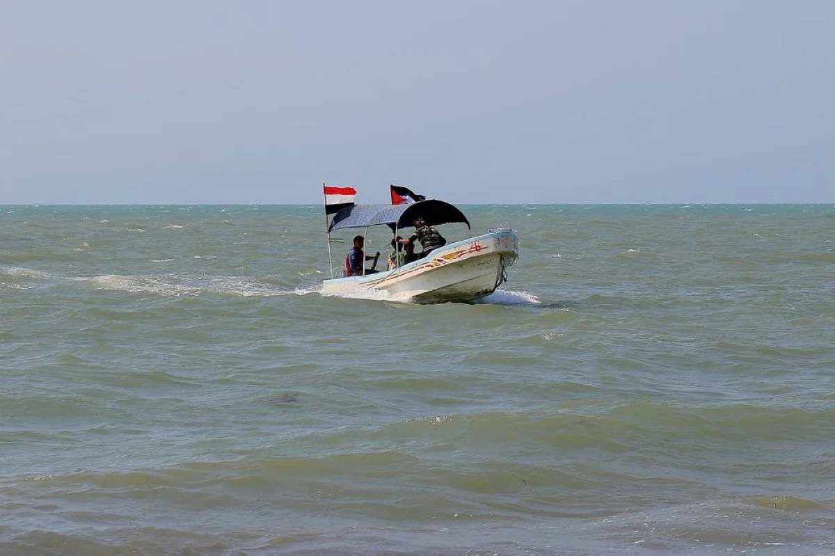 HODEIDA: Yemenis ride in a fishing boat bearing the national and the Palestinian flags in the Red Sea port of Hodeida, amid continuing fighting in Gaza. US and British forces hit rebel-held targets in Yemen’s capital Sanaa, the western province of Hodeida and the northern district to Saada.- AFP