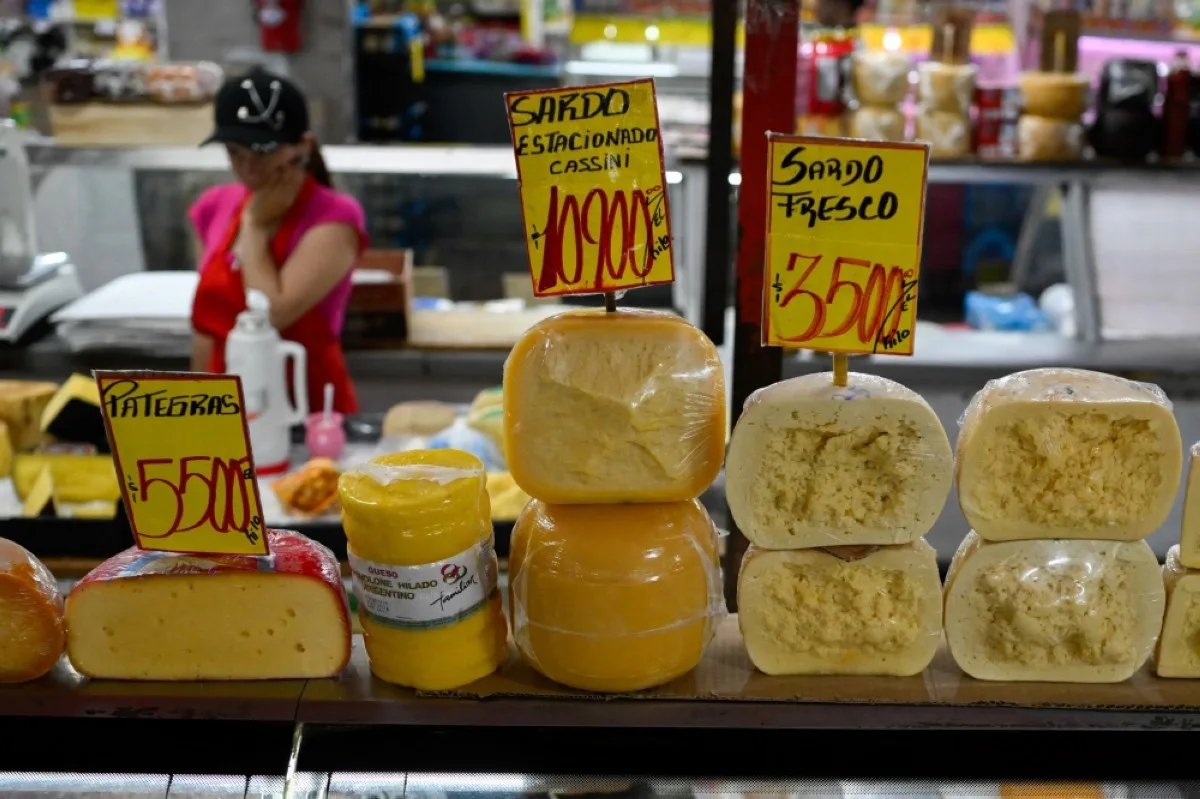 BUENOS AIRES, Argentina: Signs show the price of the different cheeses at the Central Market in Buenos Aires. – AFP