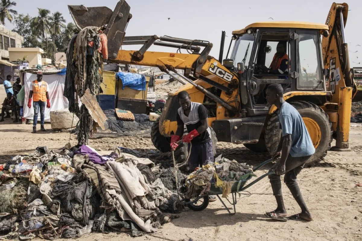 DAKAR, Senegal: Men pile waste collected from the beach during a beach clean up along Hann Bay in Dakar on November 11, 2023. --AFP