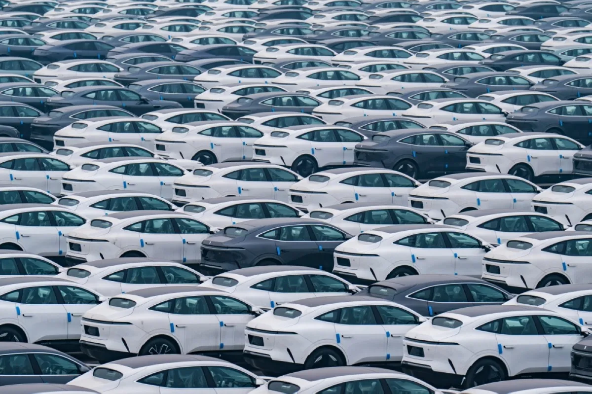 The photo taken on January 14, 2024 shows new energy vehicles parked at a distribution center of Changan Automobile Company in China's southwestern Chongqing municipality. (Photo by AFP) / China OUT / CHINA OUT