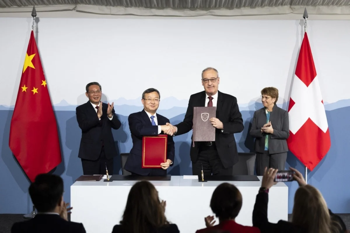 KEHRSATZ, Switzerland: Swiss Federal Minister Guy Parmelin (front right), and Wang Shouwen, Chinese Vice Minister of the Ministry of Commerce, shake hands after signing a joint statement of the free trade agreement during an official visit to Kehrsatz on Jan 15, 2024. – AFP