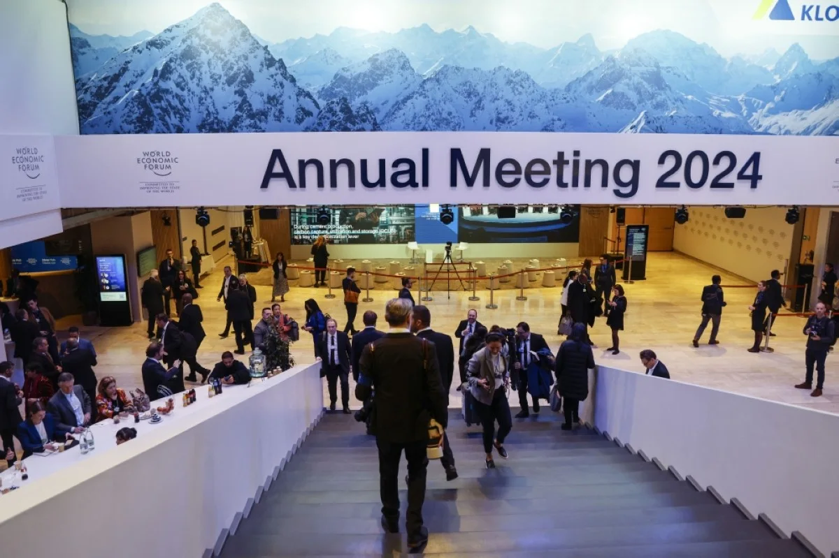 DAVOS: Participants use a staircase under signage which reads "Annual Meeting 2024" at the World Economic Forum (WEF) meeting in Davos on January 17, 2024. --AFP