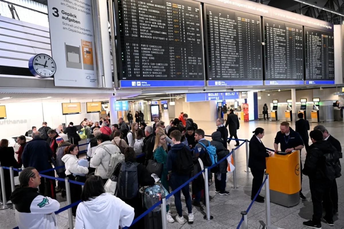 FRANKFURT: Passengers queue to rebook their flights at the airport in Frankfurt am Main, western Germany, on January 17, 2024, as severe winter weather warnings prompted the cancellation of hundreds of flights. -- AFP