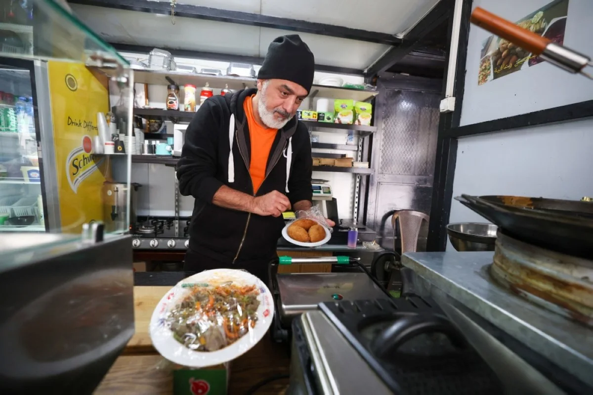 AL-BIREH, Palestinian Territories: Hafeth Ghazawneh waits for customers to visit his falafel stall in the occupied West Bank city of Al-Bireh. – AFP