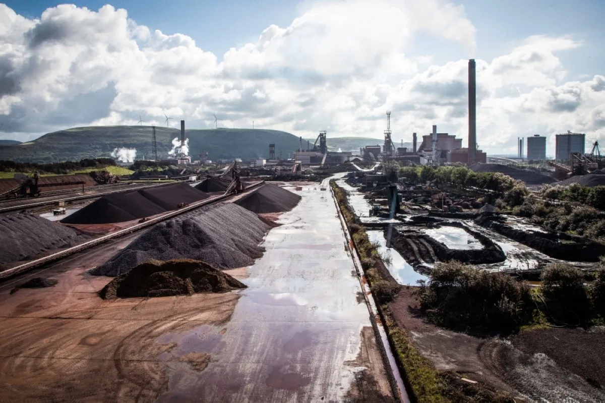 PORT TALBOT, United Kingdom: Raw materials to make iron sit in heaps at the Tata Steel Port Talbot integrated iron and steel works in south Wales. -- AFP