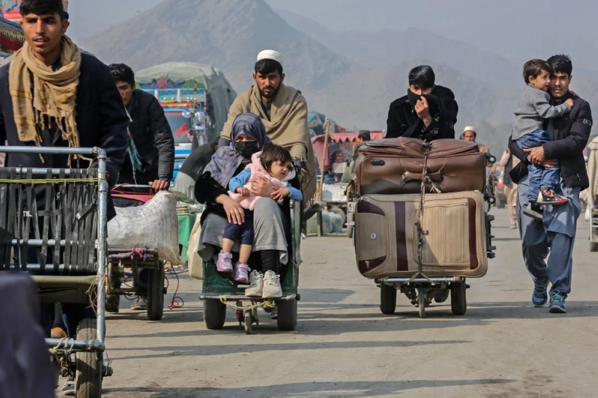 TORKHAM, Afghanistan: Afghan people along with their belongings arrive to enter Pakistan near the zero point Torkham border crossing between Afghanistan and Pakistan, in Nangarhar province on January 23, 2024. -- AFP