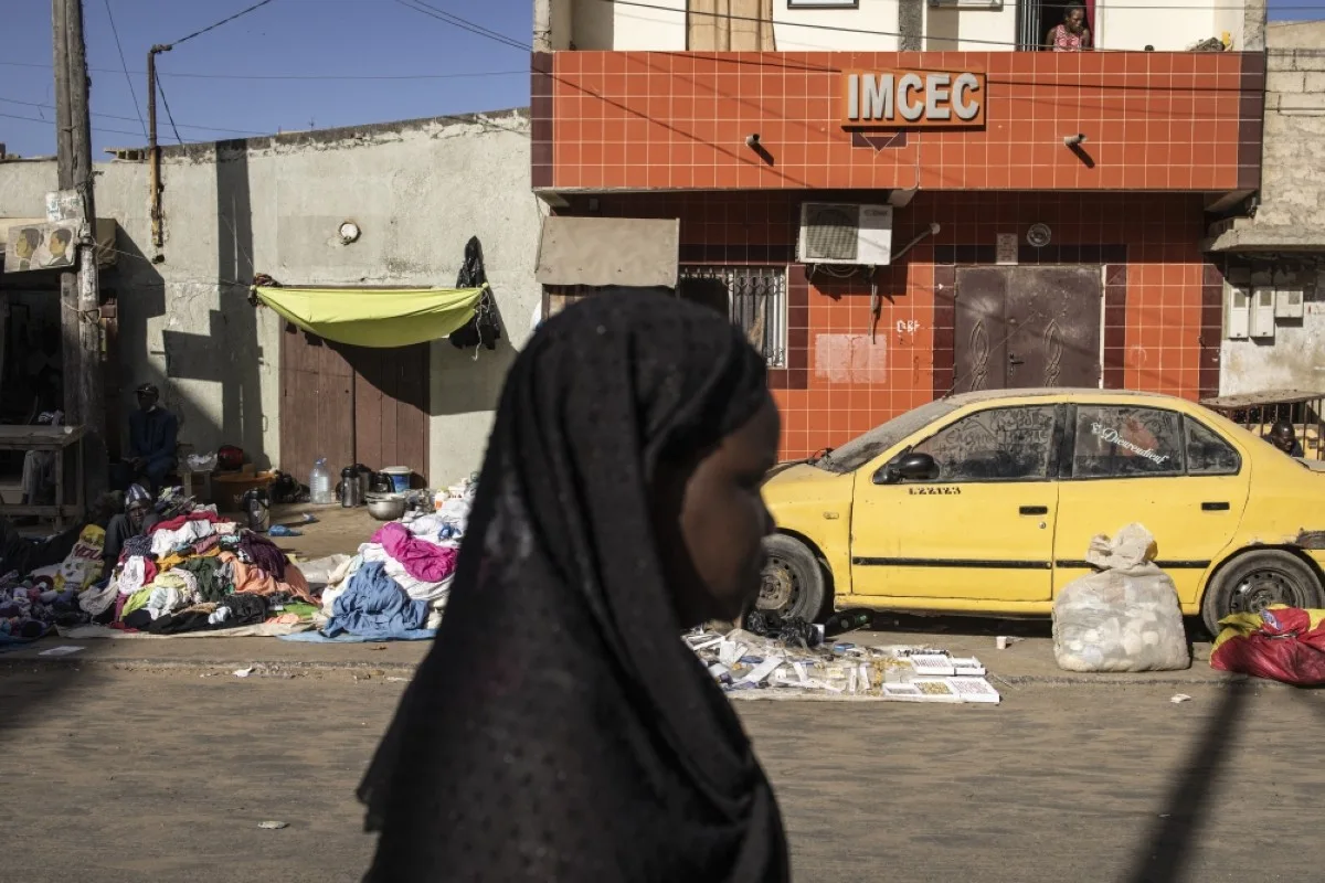DAKAR: A woman walks down a road in the popular Yoff neighborhood in Dakar. – AFP
