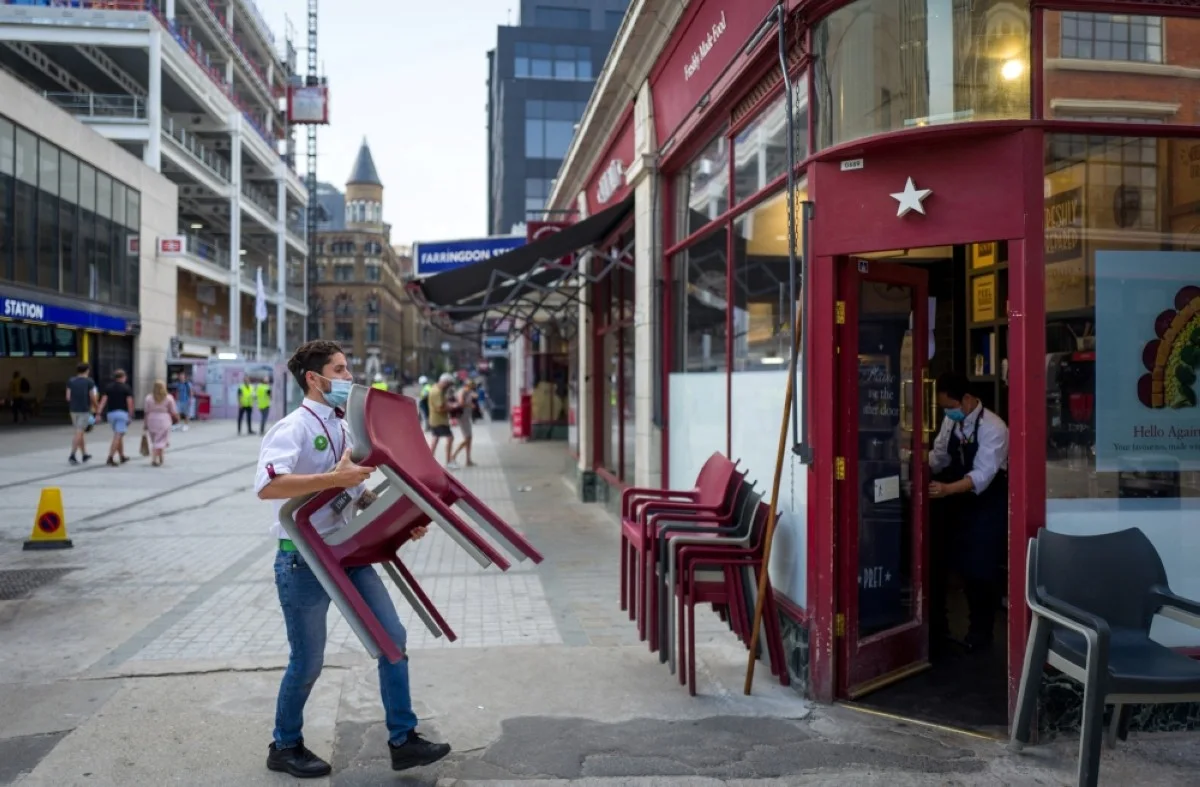 LONDON: A worker puts away chairs in London. Britain is in recession, official data showed Thursday, dealing another blow to embattled Prime Minister Rishi Sunak.- AFP