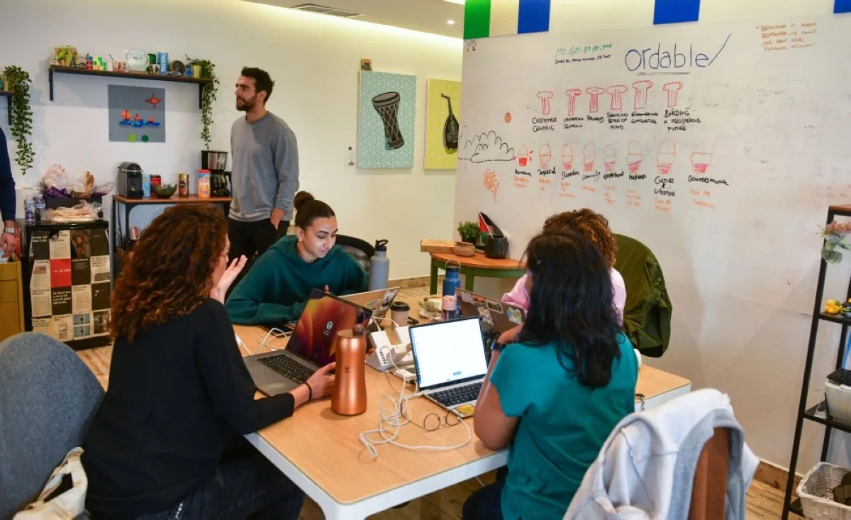 Co-founder Mona Al-Baker discussing work with her team