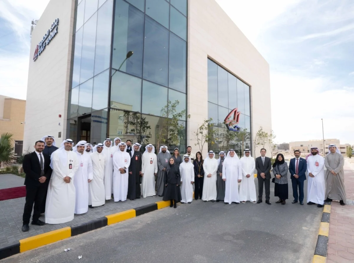 A group photo of Gulf Bank's executive management officials in front of the new branch.