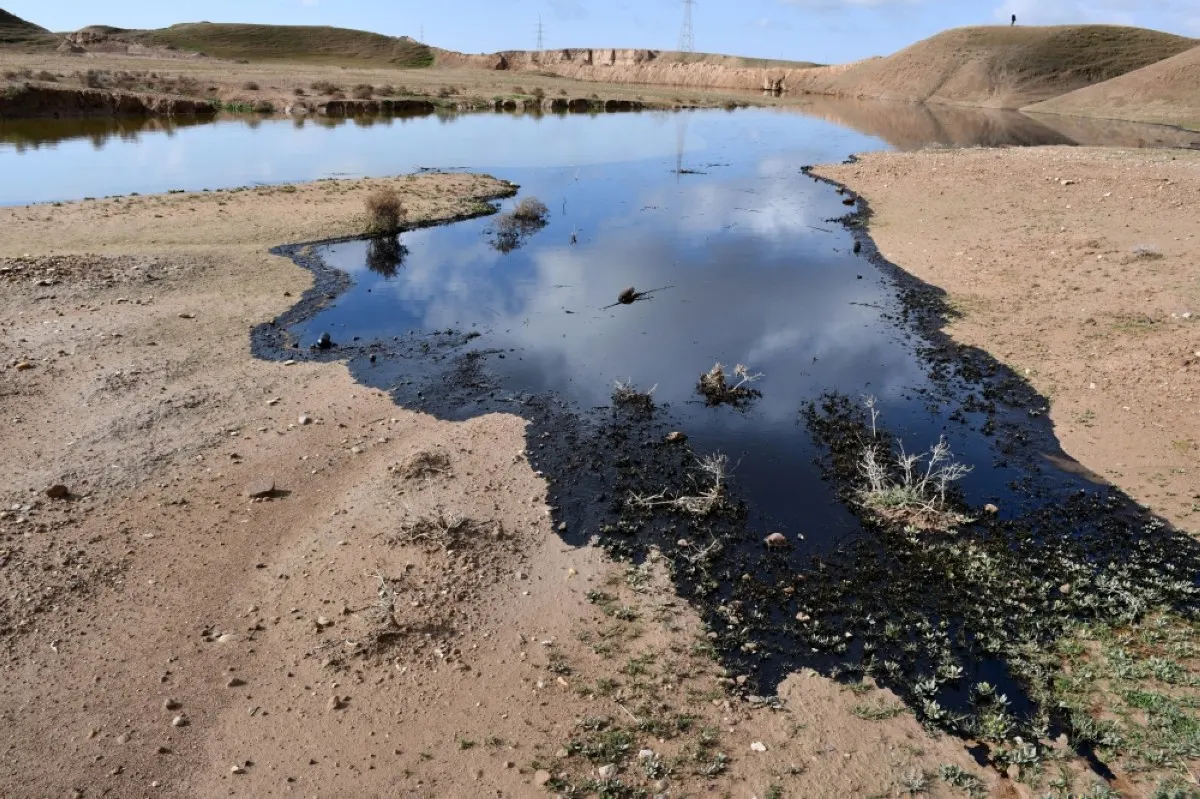 A picture shows an oil spill into an agricultural land in the region of Hamrin, north of Tikrit, in Iraq's province of Salaheddin. – AFP