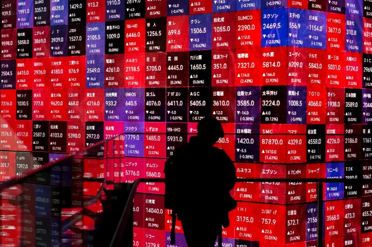 TOKYO: Electronic board displays stock prices of companies listed on the Tokyo Stock Exchange along a street in Tokyo. -- AFP
