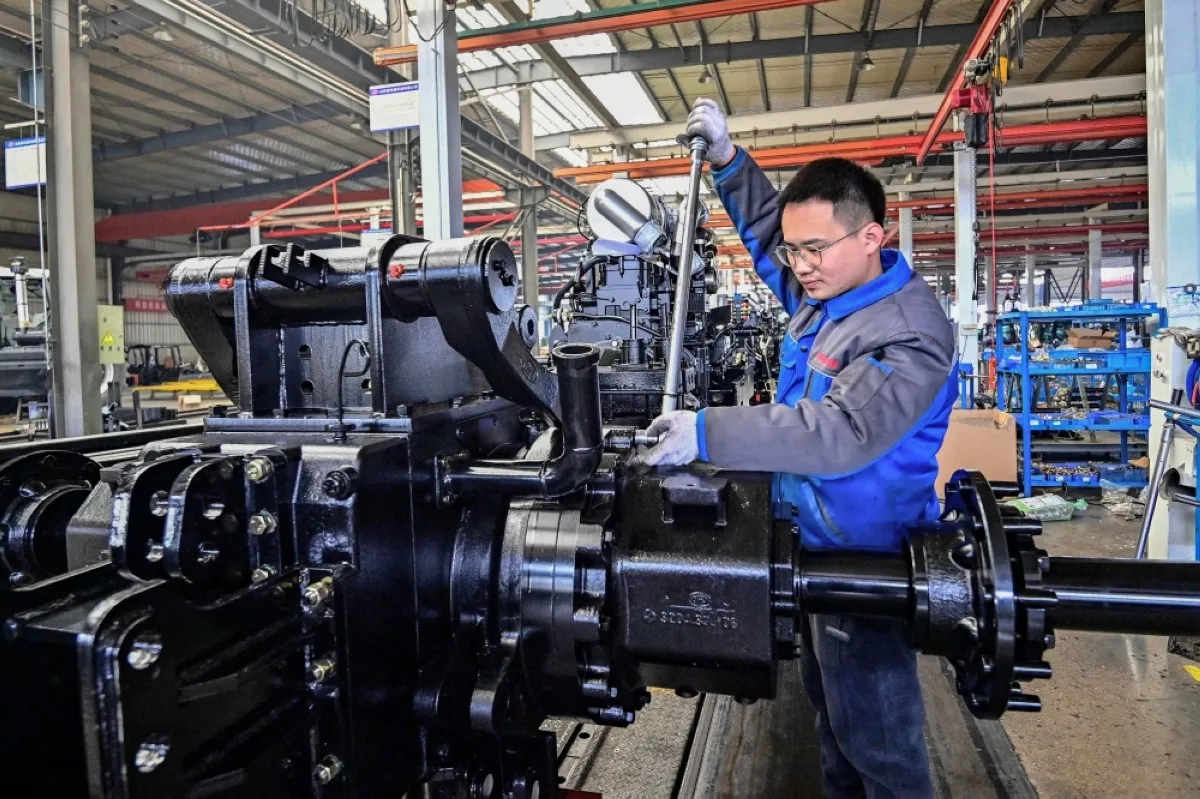 WEIFANG, China: An employee works on a tractor production line at a factory in Weifang, in China's eastern Shandong province on March 1, 2024. -- AFP