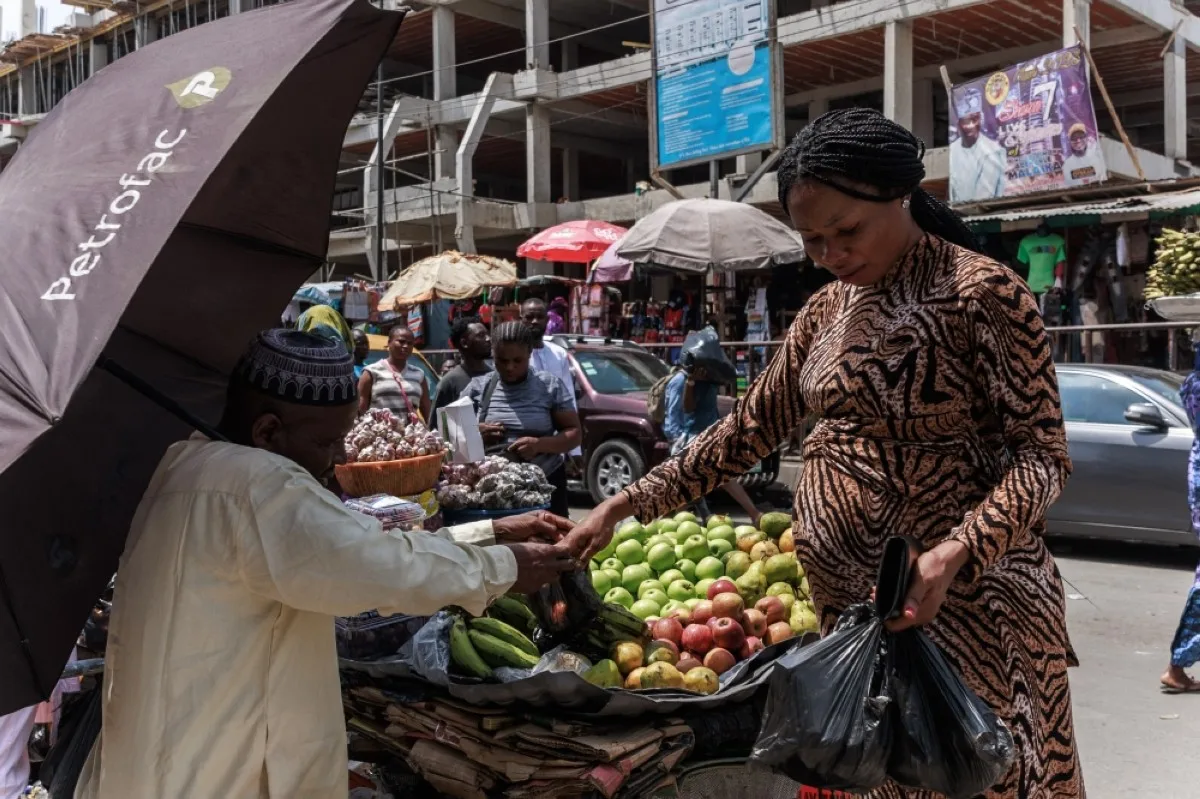 LAGOS: A woman buys fruits at the Lagos Island market in Lagos on March 8, 2024 ahead of the holy fasting month of Ramadan. – AFP