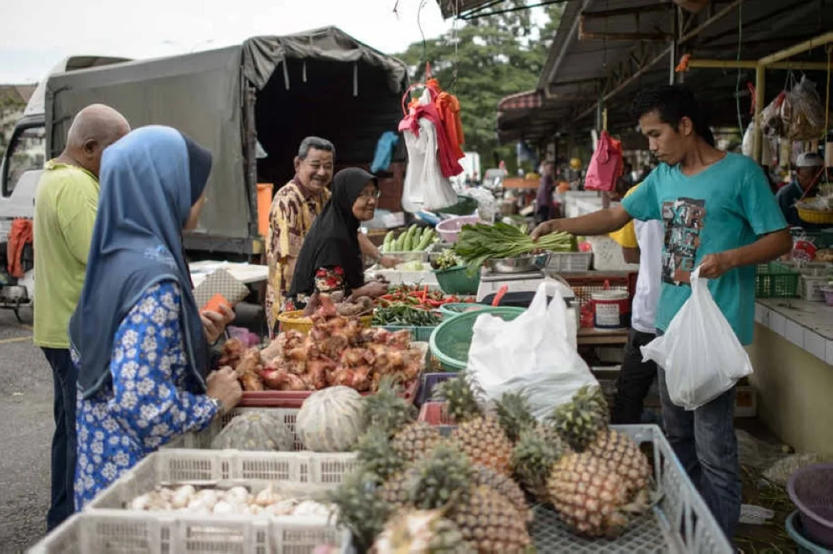 People buy groceries at a market in Ampang, Kuala Lumpur. – AFP