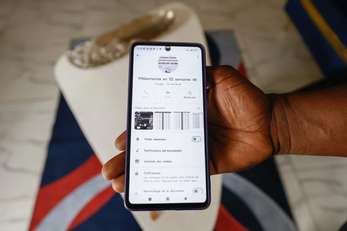 YAOUNDÉ, Cameroon: This photograph taken in Yaounde, on Feb 17, shows an example of a WhatsApp group dedicated to discussions of tontines.
