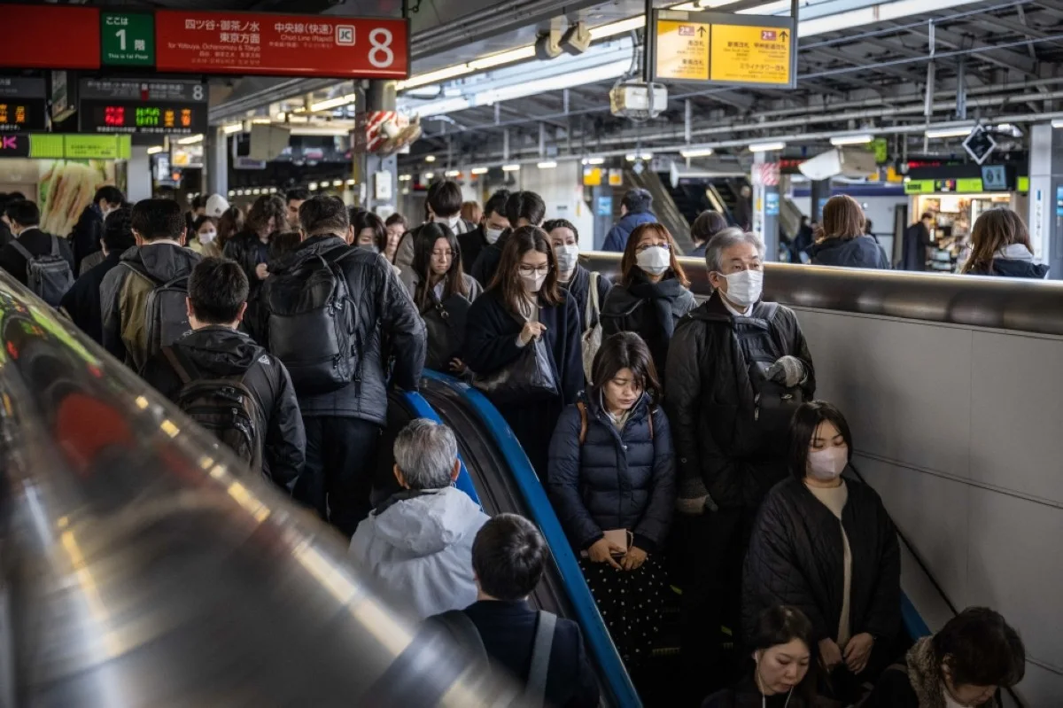People pass through Shinjuku station in Tokyo on March 15, 2024. -- AFP