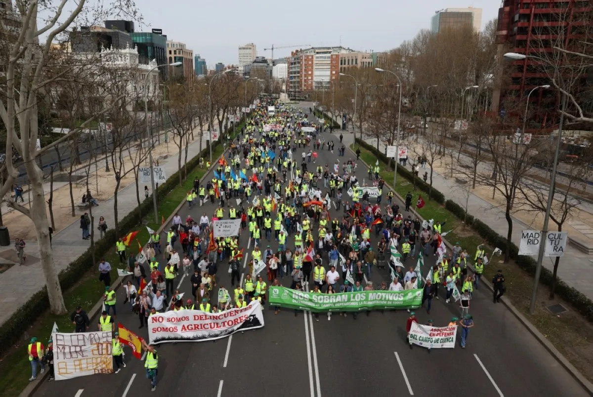 MADRID; Farmers hold banners reading "We are not hooligans, we are farmers", "The agriculture sector is dying" during a protest organized by "Union de Uniones" union, in central Madrid, on March 17. -- AFP