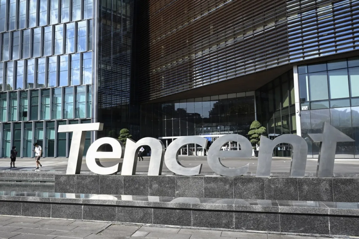 SHENZHEN, China: People walking past the Tencent headquarters in Shenzhen in China's southern Guangdong province. – AFP