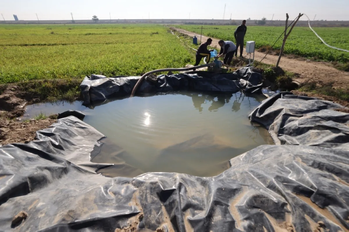 AL-AZRAKIYA, Iraq: Farmers set up the sprinklers on a farm in the village of Al-Azrakiya, in Iraq's central province of Anbar. – AFP