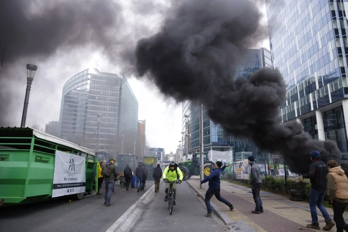 BRUSSELS: A man throws a projectile during a demonstration by farmers on the occasion of a EU agriculture ministers meeting in Brussels, on March 26, 2024. -- AFP
