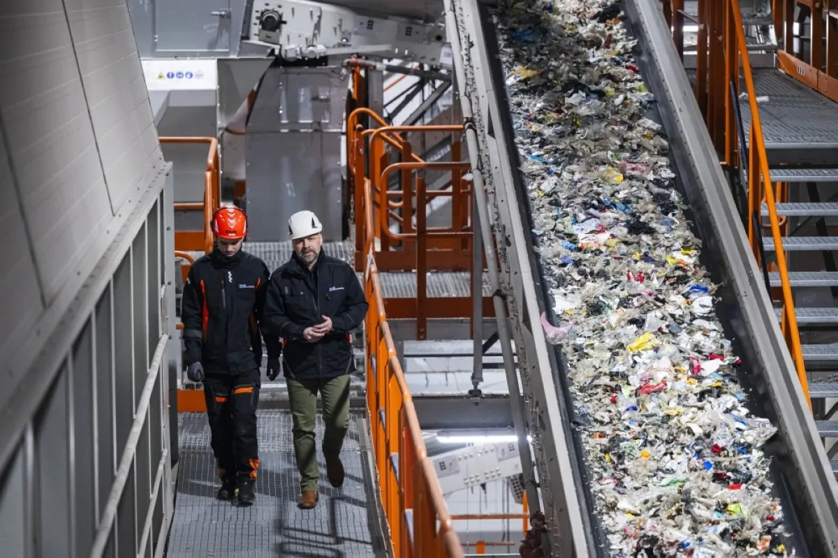 MOTALA, Sweden: Mattias Philipsson, CEO of Svensk Plastatervinning walks with an employee at the Site Zero recycling facility in Motala, Sweden. -- AFP

