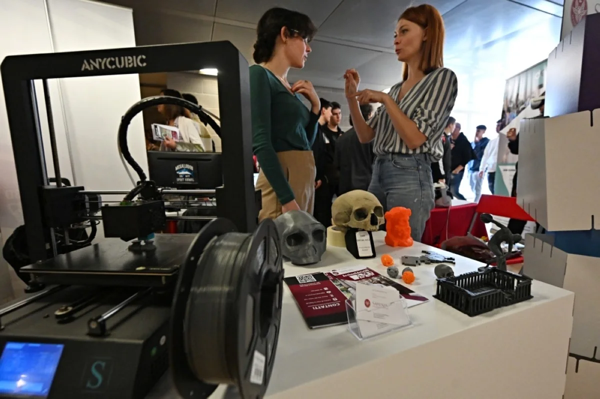 ROME: Students stand next to a 3D printer for the reconstruction of archaeological finds during the RomeCup 2024 focusing on "Artificial Intelligence and Robotics for the challenge of holistic sustainability", an event dedicated to the frontiers of technological development, at the University of Tor Vergata, in Rome. – AFP