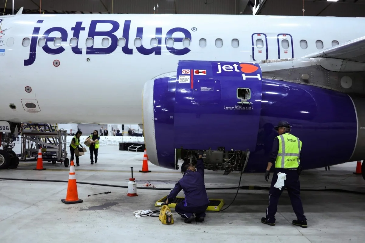 NEW YORK: Employees of Jet Blue airlines work on an engine of an Airbus A320 passenger aircraft in a maintenance hangar of the company at JFK International Airport in New York on March 4, 2024, prior of a Career Discovery Week event. - AFP
