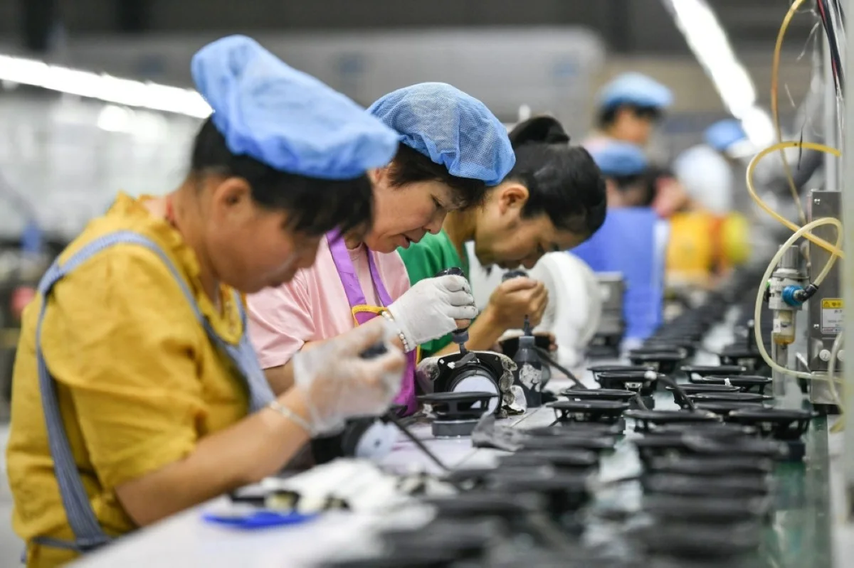 Employees in China work on an assembly line producing speakers at a factory in Fuyang in China's eastern Anhui province. – AFP