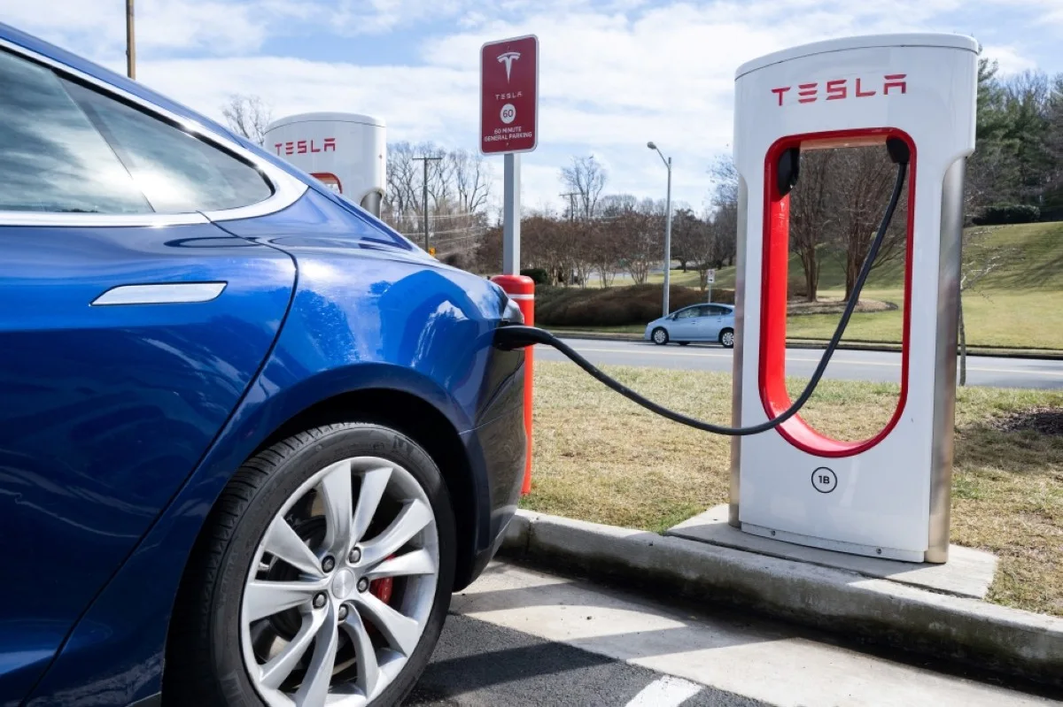 FALLS CHURCH, US: A Tesla Model S sedan is plugged into a Tesla Supercharger electrical vehicle charging station in Falls Church, Virginia. – AFP