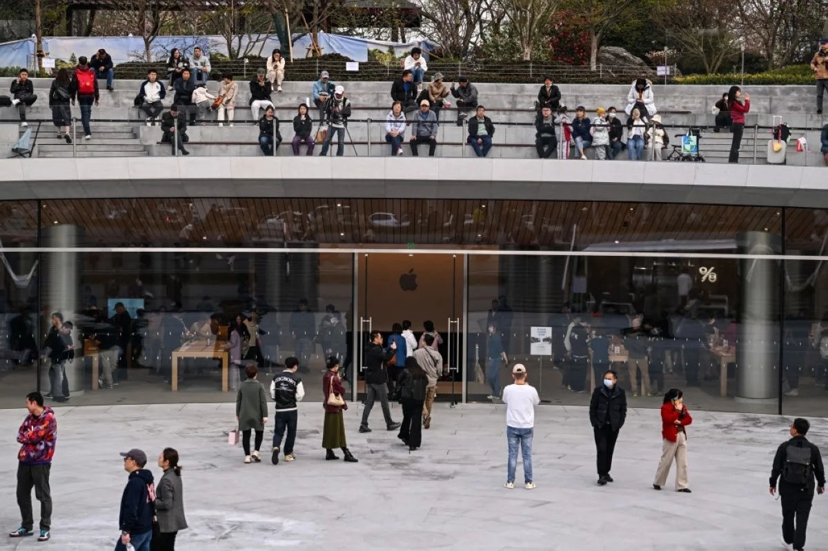 SHANGHAI: People gather at quad area outside a recently-opened Apple Store in Shanghai’s Jingan district.- AFP