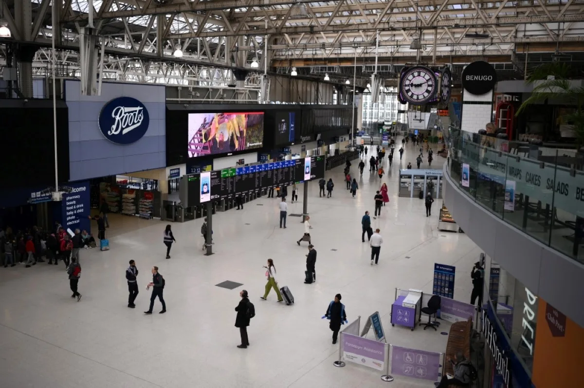 LONDON: Commuters walk at Waterloo Station in London. – AFP