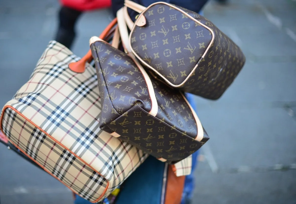 ROME: A seller carries counterfeit bags on a street in this file photo.