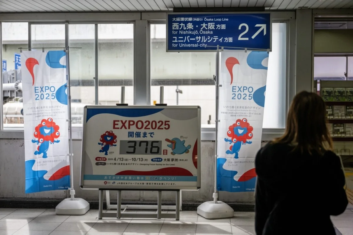 OSAKA: File photo shows a woman walking past a countdown board for the 2025 Expo at a station in Osaka. Organisers say construction is largely on schedule in the western Japanese city of Osaka, with one year to go before visitors are welcomed under the imposing “Grand Roof”—one of the largest wooden structures ever built. – AFP