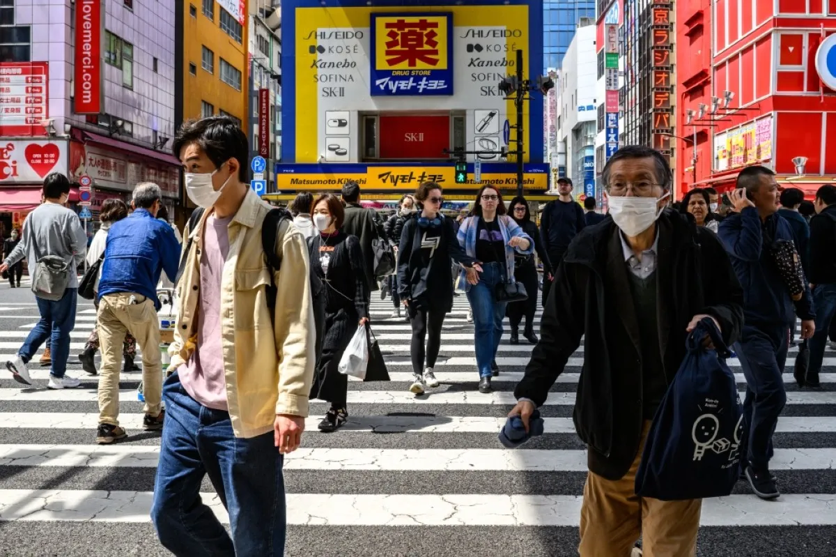 TOKYO: People walk in the shopping area of Tokyo's Akihabara district. – AFP