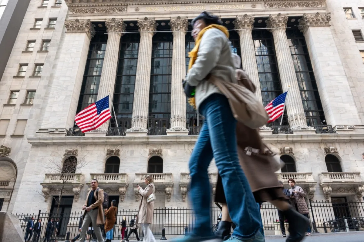 NEW YORK: People walk past the New York Stock Exchange (NYSE) in New York City. – AFP