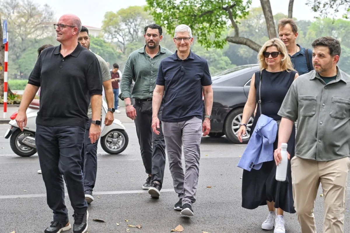 HANOI: Apple CEO Tim Cook (center) walks near Hoan Kiem lake in downtown Hanoi during his visit to Vietnam on April 15, 2024. Tech giant Apple said it would increase spending on suppliers in Vietnam, a key production hub, as CEO Tim Cook arrived in the country for a two-day visit. – AFP