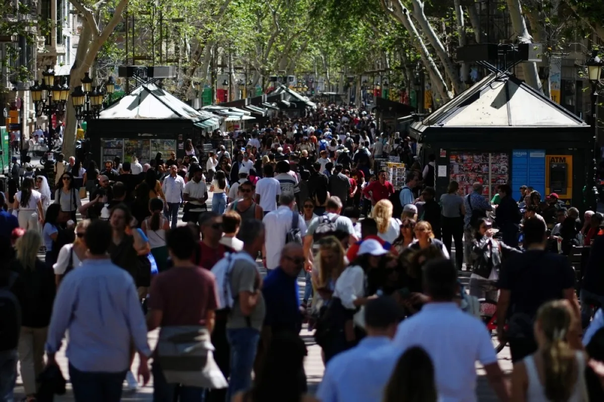BARCELONA: Tourists walk up and down Las Ramblas alley in Barcelona. – AFP