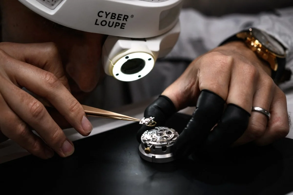 GENEVA: A watchmaker shows the ‘cyberloupe’ a digitalized magnifying glass that can livestreaming, created by luxury Swiss watch manufacturer IWC, on the opening day of the Watches and Wonders Geneva show.- AFP