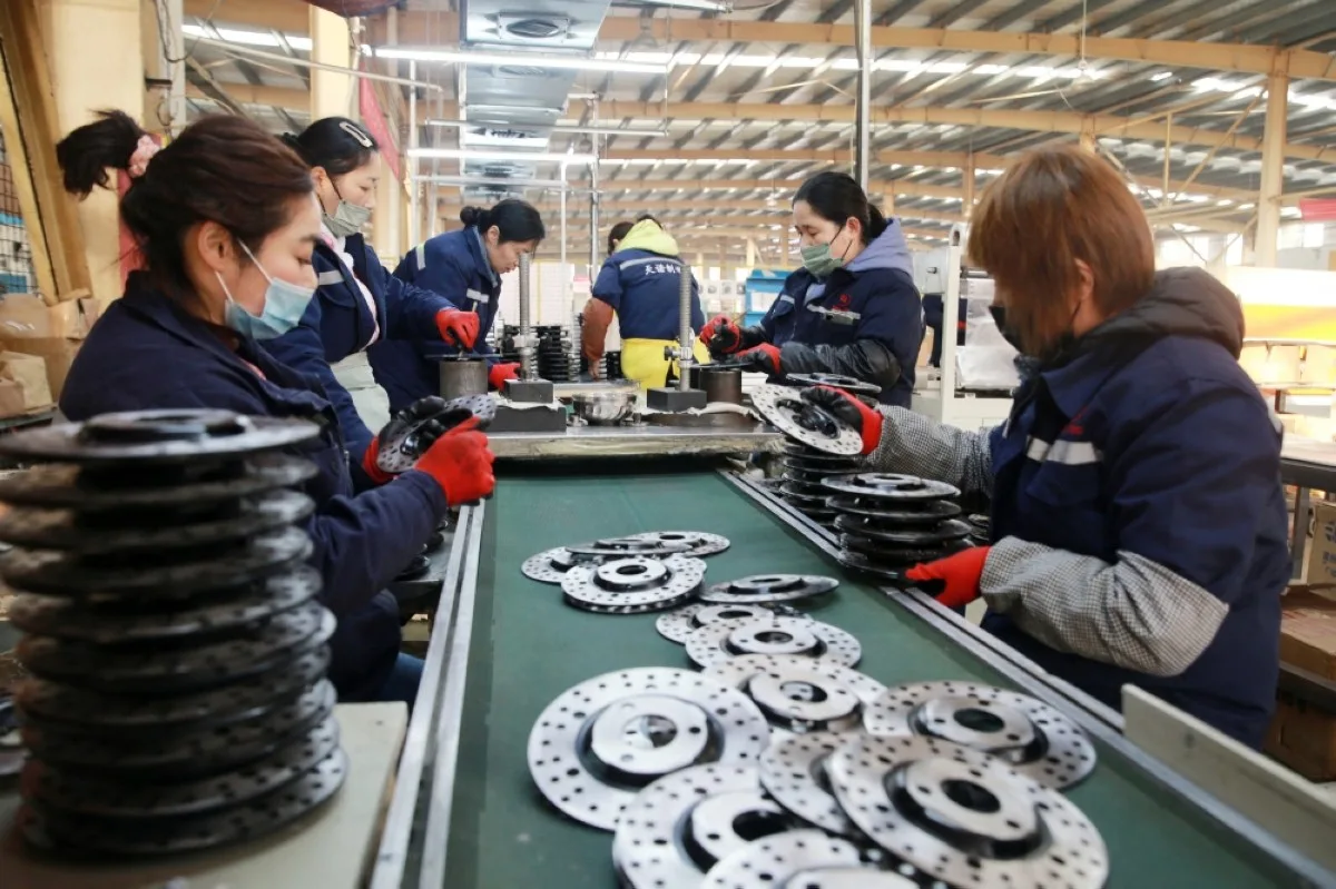 HUAIBEI: Employees work on aluminum products at a factory in Huaibei, in China’s eastern Anhui province. - AFP