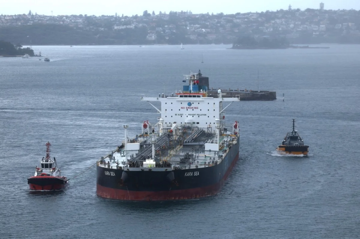 SYDNEY:  Tugboats escort a crude oil tanker, Kara Sea, through Sydney Harbor.- AFP