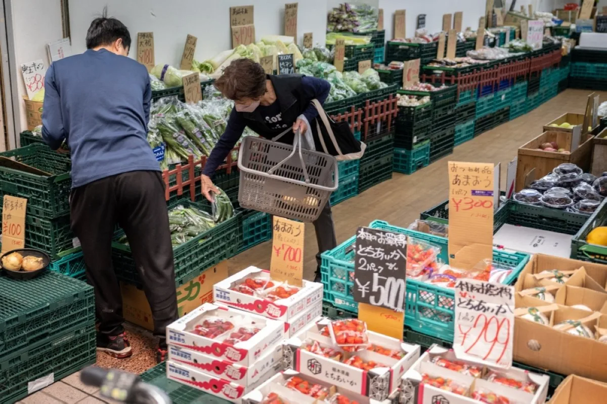 TOKYO: A customer shops for groceries at a supermarket in Tokyo.- AFP