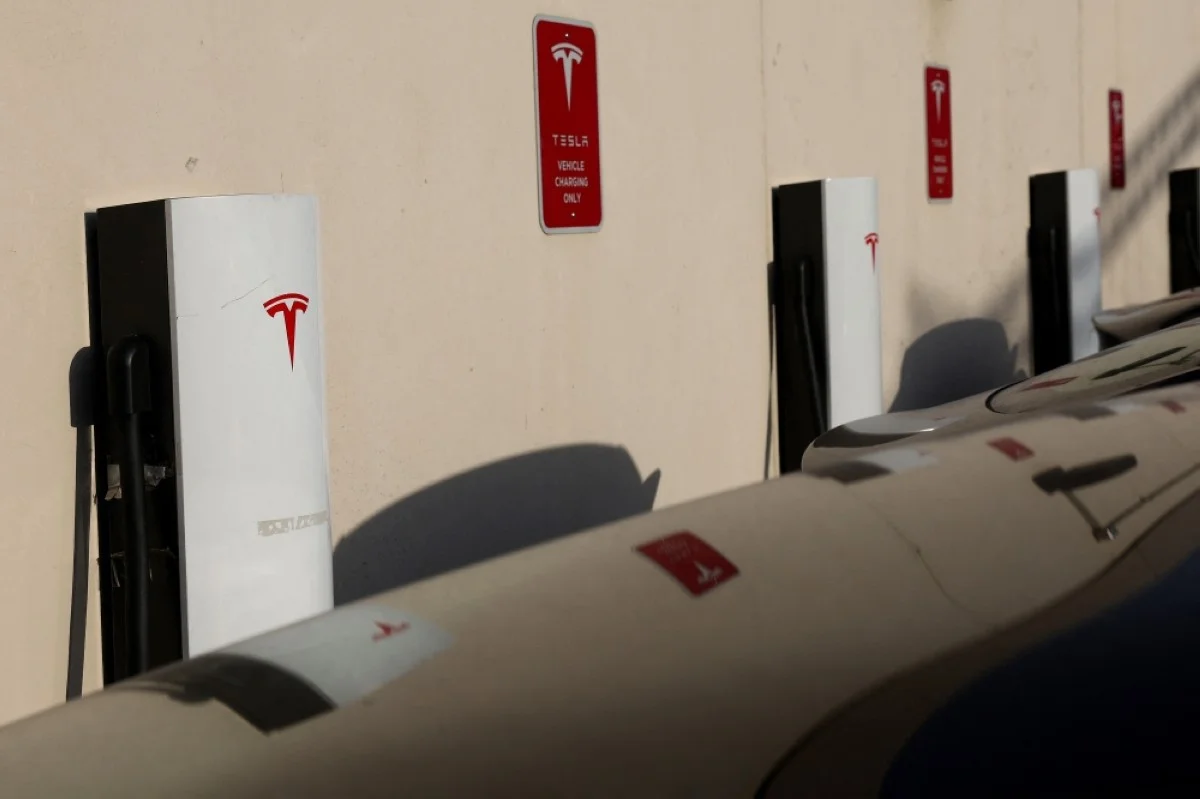 CHICAGO: Tesla vehicles charge in a parking lot in Chicago, Illinois. – AFP