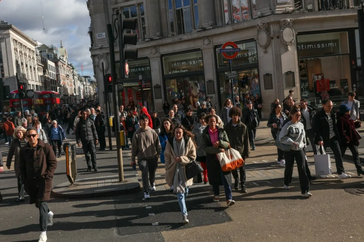 LONDON: Pedestrians walk in the winter sunshine down Oxford Street in central London.- AFP