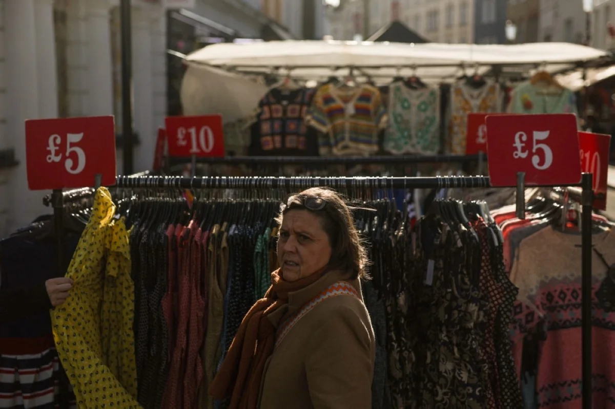 LONDON: Price tags are seen on racks of clothes in a street market in Portobello road, in west London.- AFP