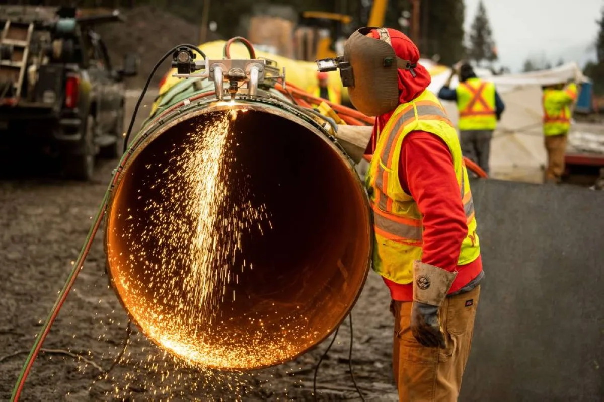 BRIDAL FALLS, Canada: This January 17, 2023, image courtesy of Trans Mountain Corporation shows a welder working on a pipeline in Bridal Falls, British Columbia, Canada. -- AFP