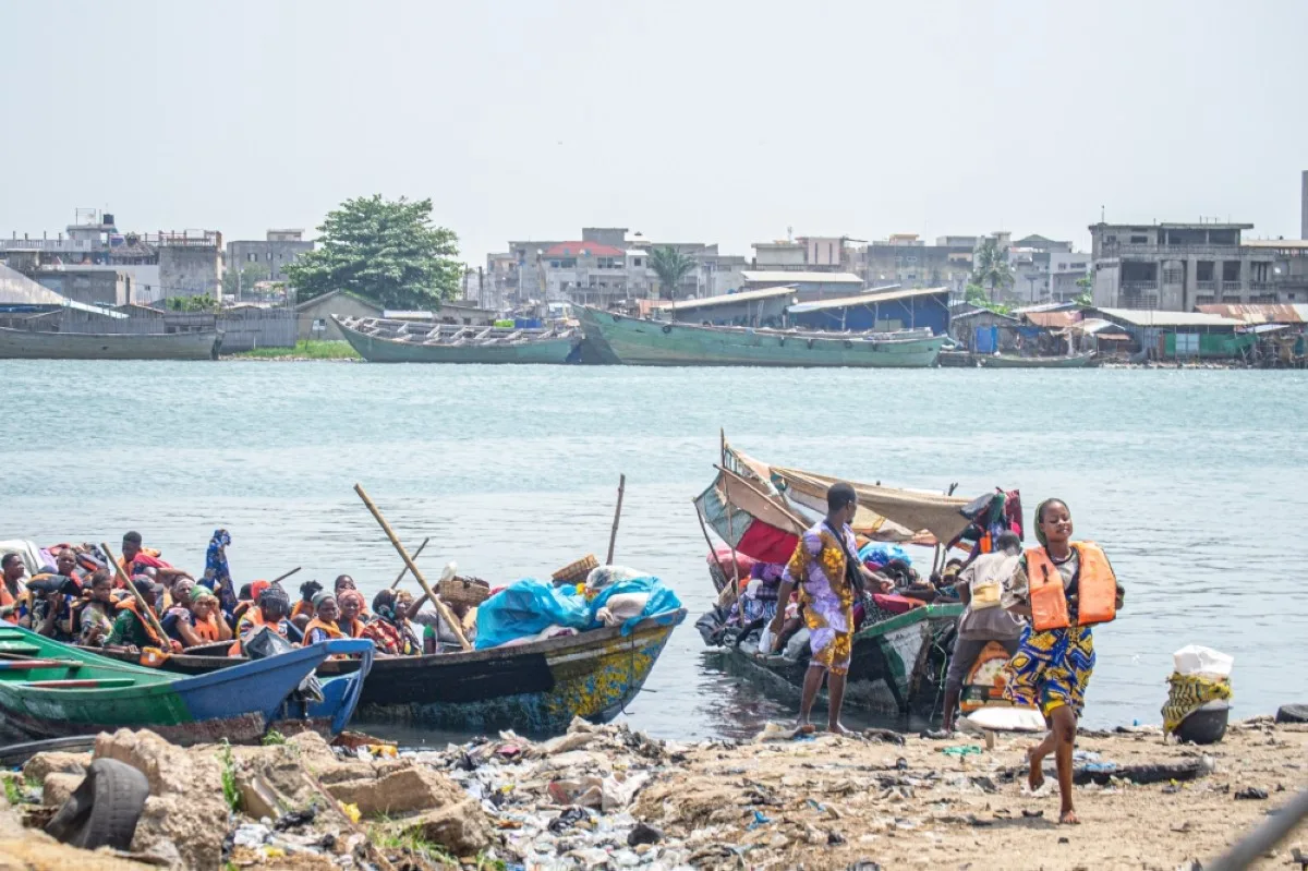 COTONOU: Boats loaded with passengers and goods moor on a shore near the Dantokpa market, one of the largest open-air market in West Africa.- AFP
